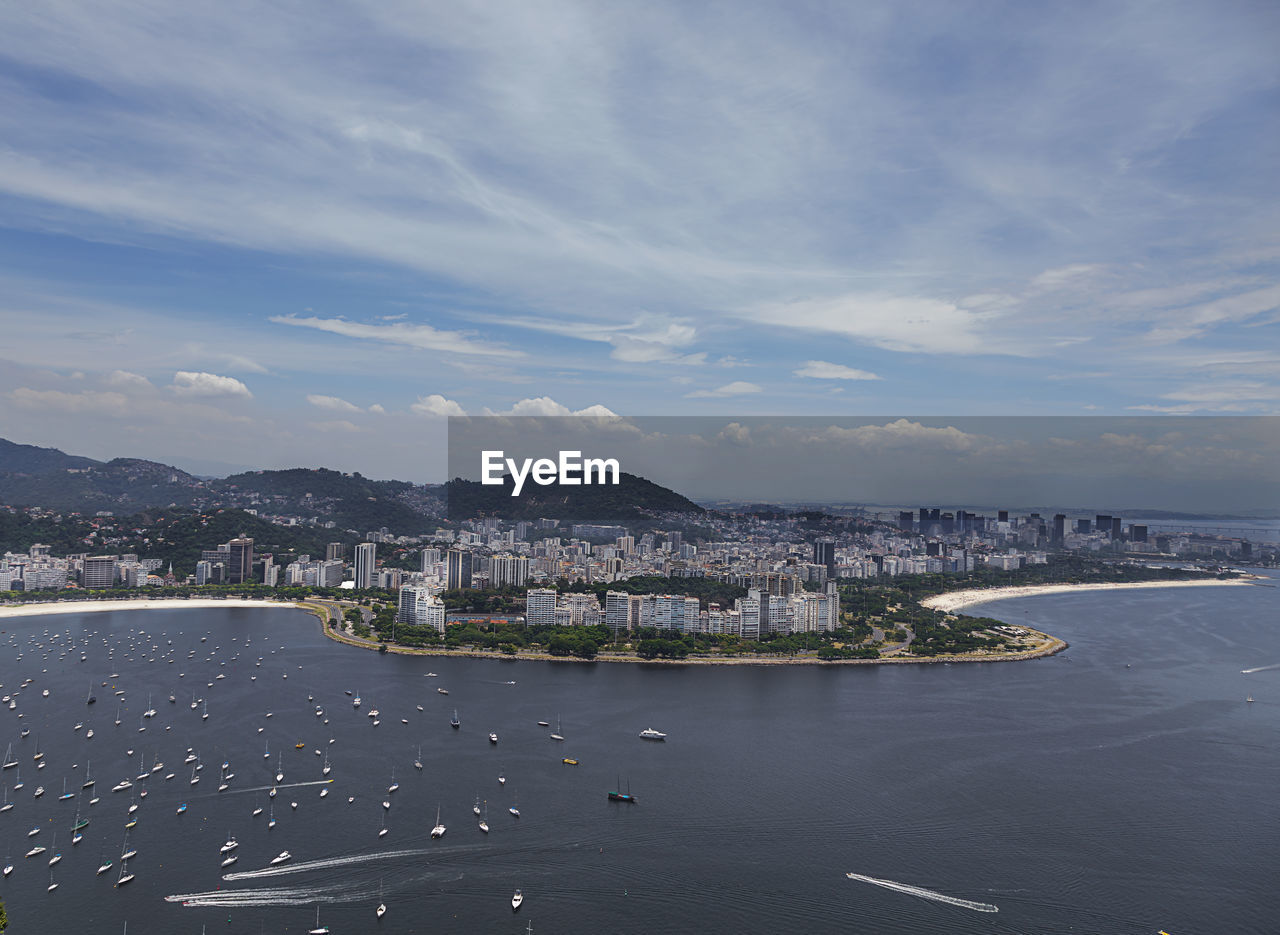 High angle view of sea and buildings against sky