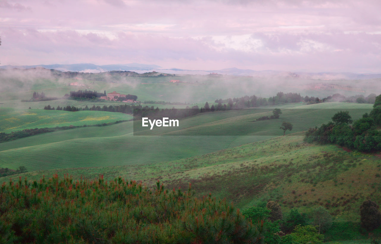 Scenic view of field against cloudy sky