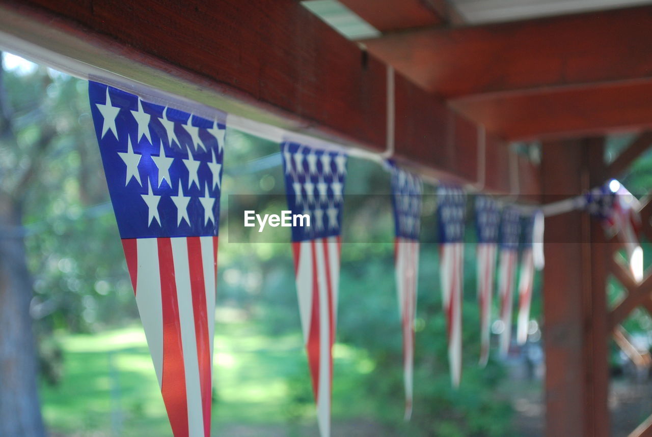 Close-up of american flags bunting hanging from roof