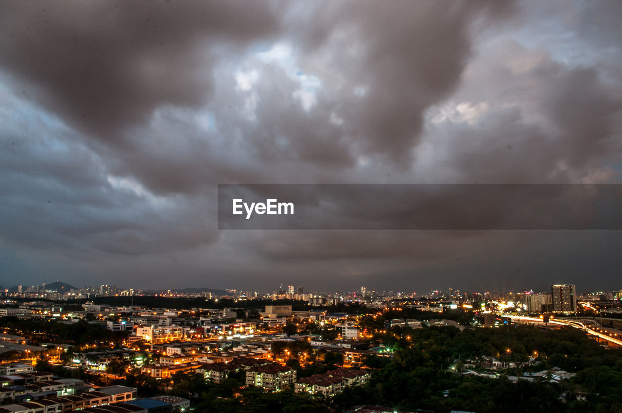 Illuminated cityscape against sky at night