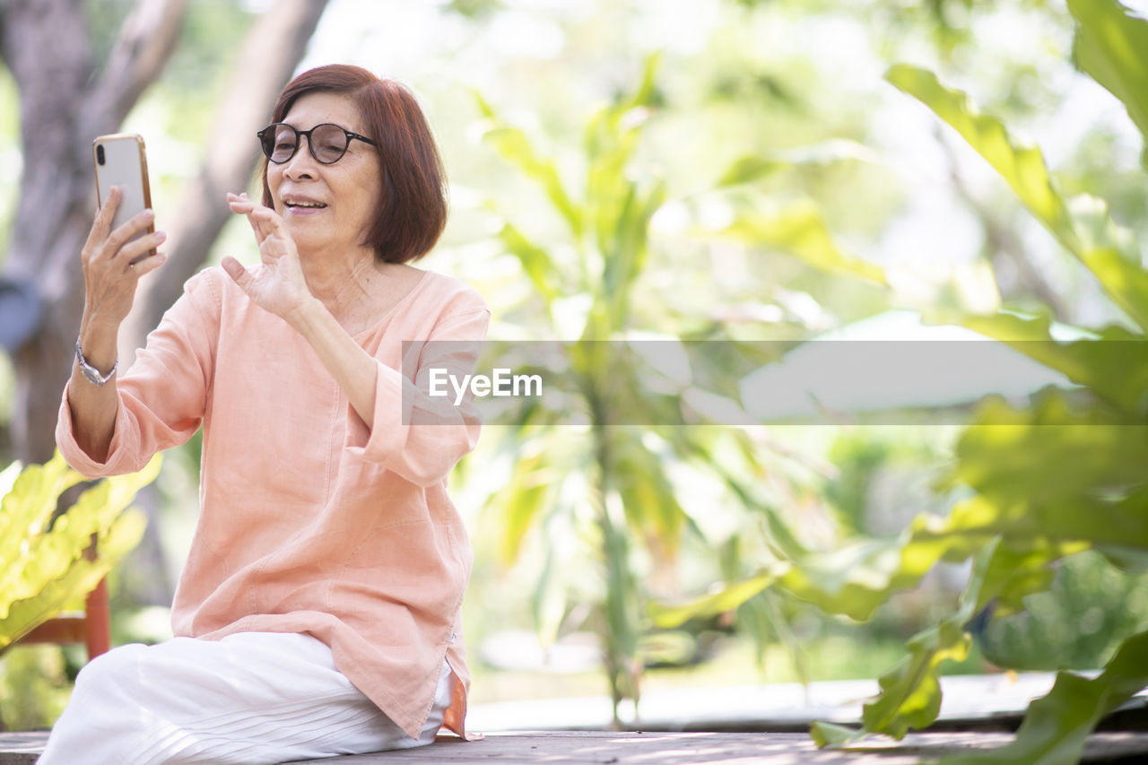 Asian elderly woman use smart phone