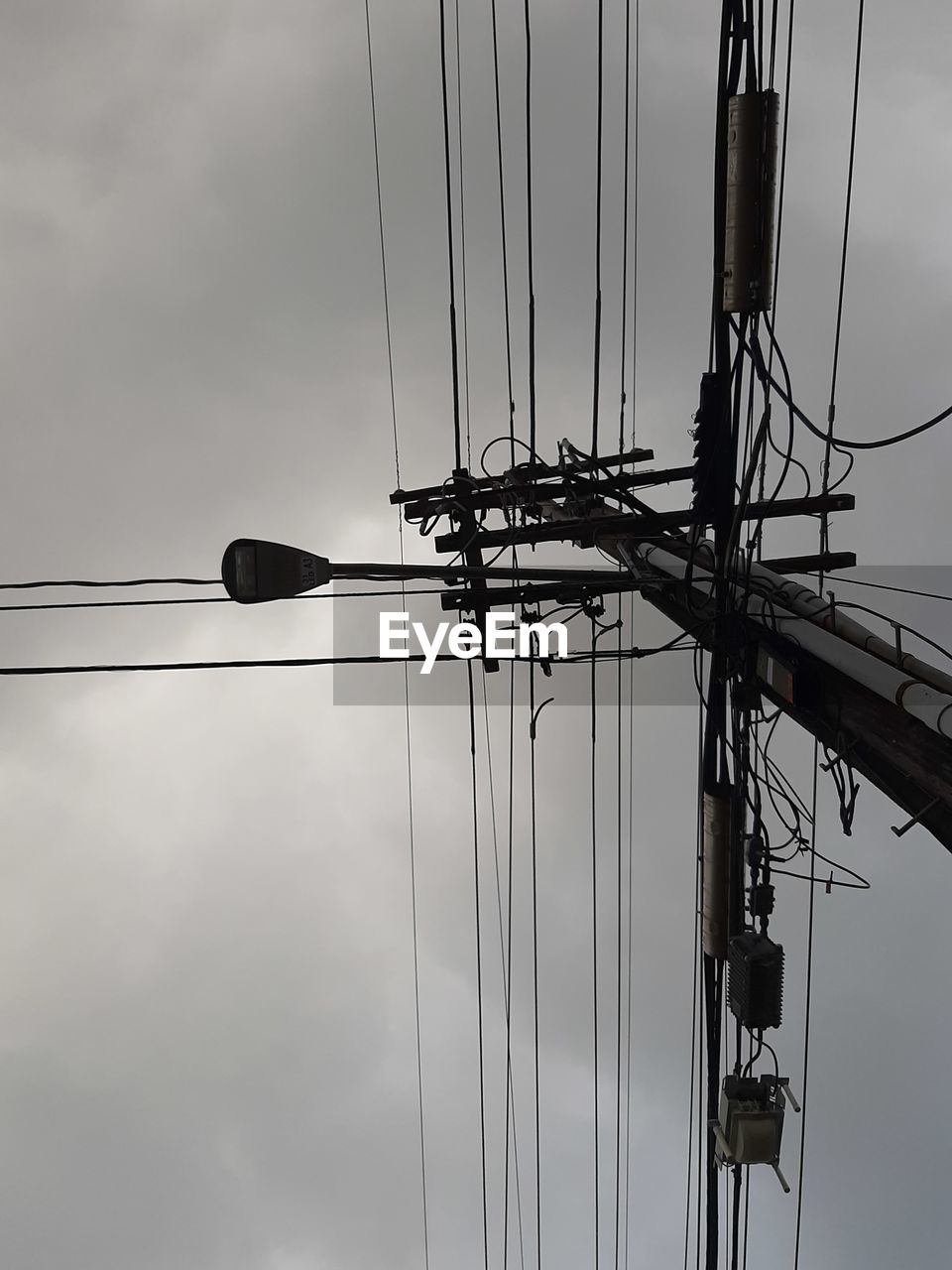 LOW ANGLE VIEW OF SILHOUETTE ELECTRICITY PYLONS AGAINST SKY