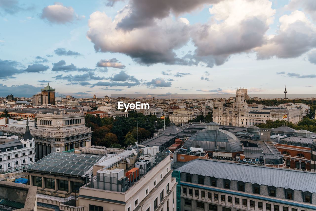 High angle view of cityscape against cloudy sky