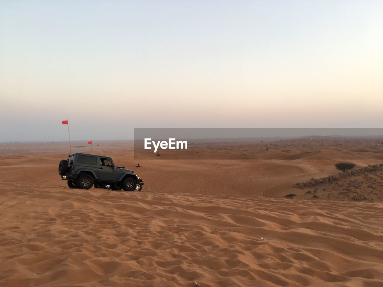 CAR ON BEACH AGAINST SKY DURING SUNSET