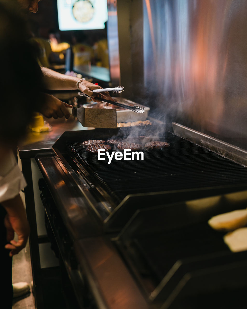 PERSON PREPARING FOOD IN KITCHEN