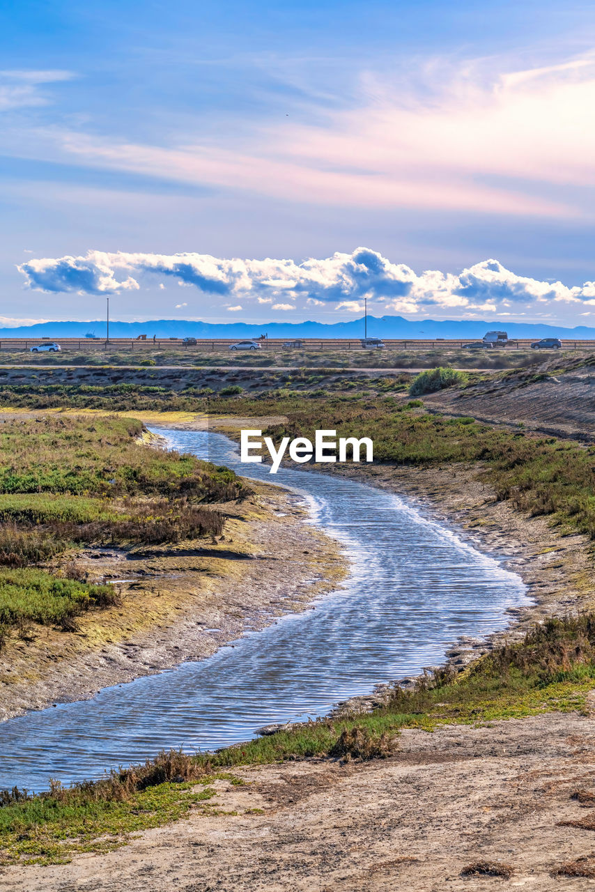 SCENIC VIEW OF SEA SHORE AGAINST SKY