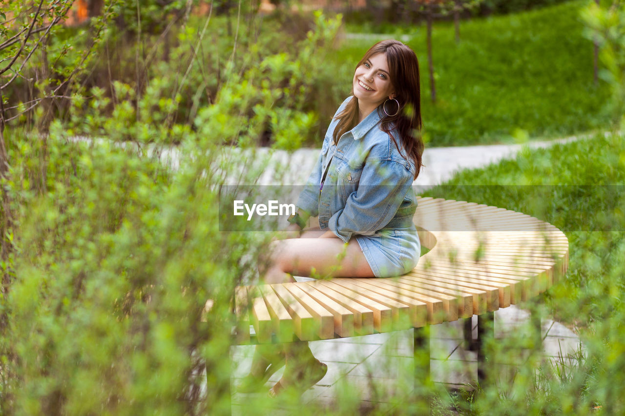 WOMAN SITTING IN A PARK