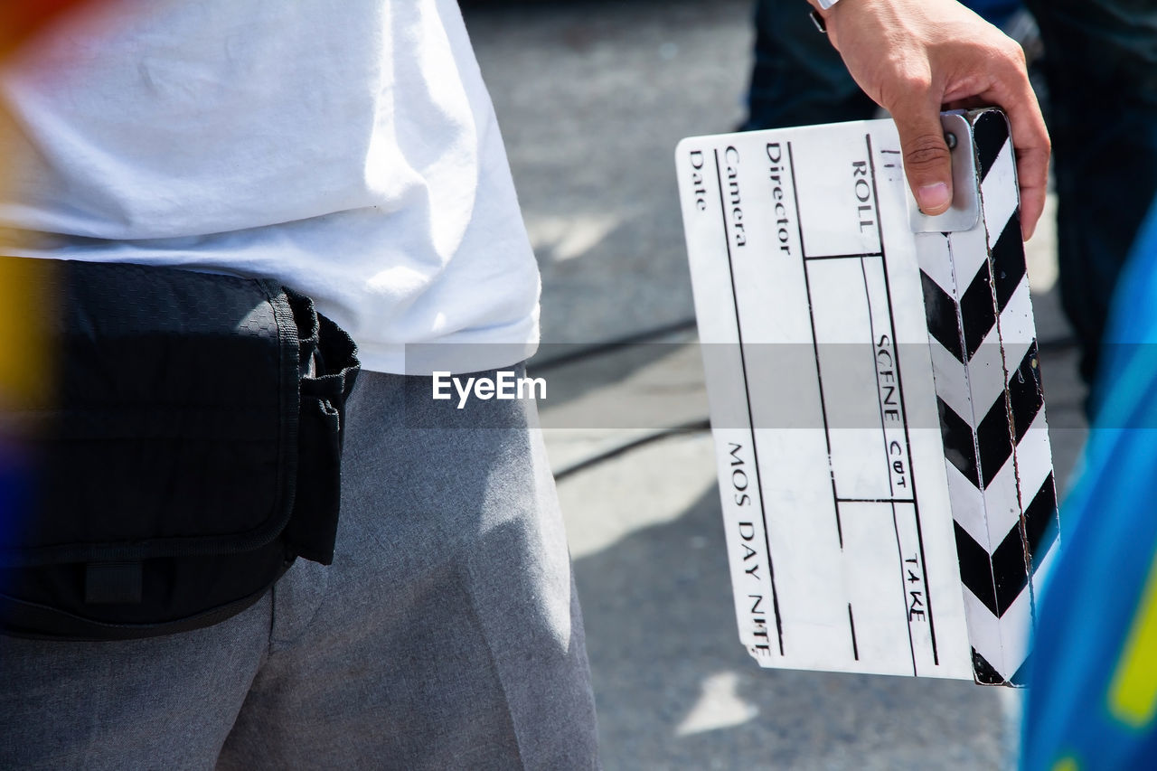 Close up image of film production crew holding film slate on set