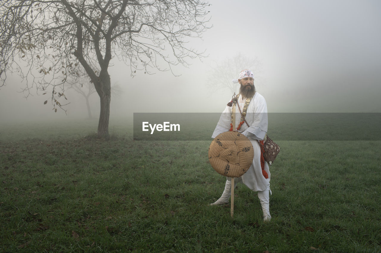 Full length of man walking on field