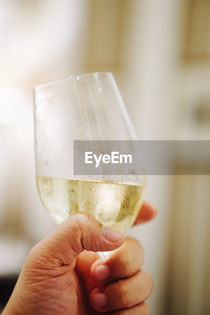 Cropped image of hand holding wineglass