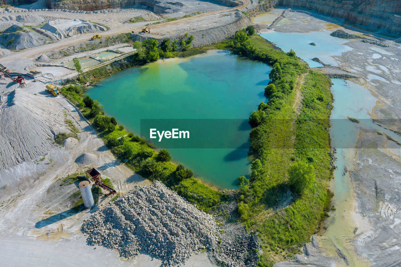 HIGH ANGLE VIEW OF PEOPLE BY SWIMMING POOL