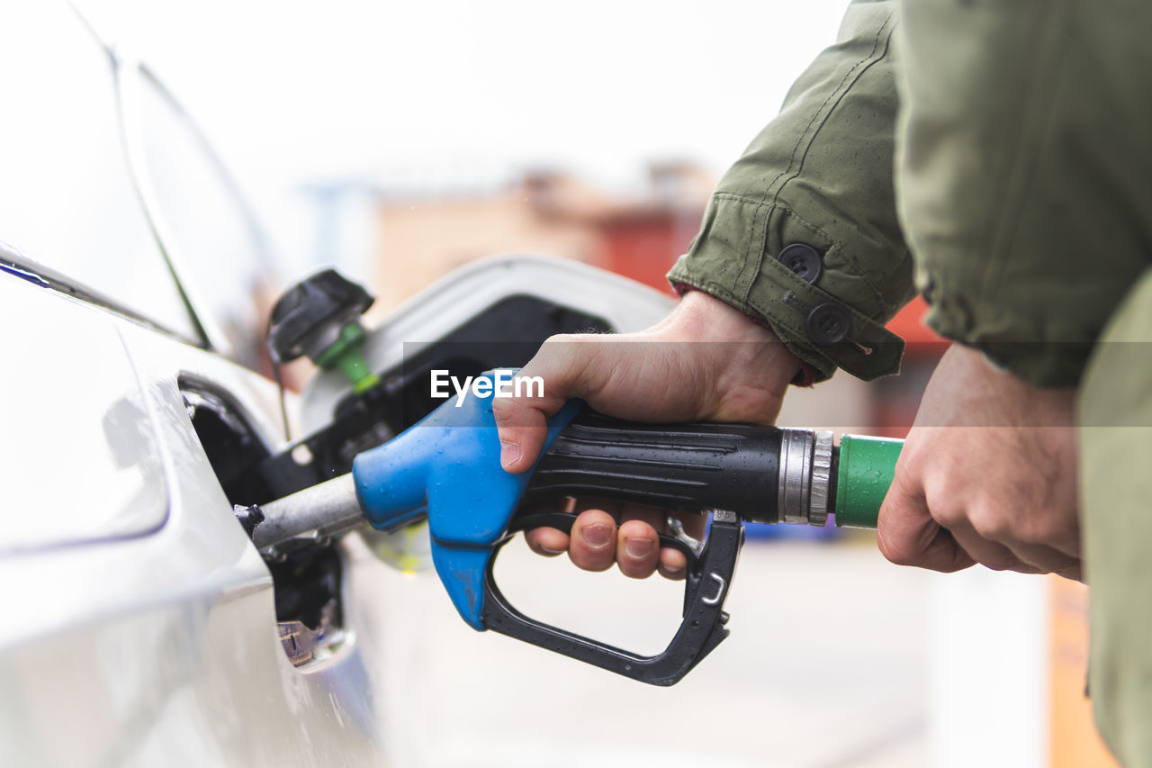 Man refueling car at gas station
