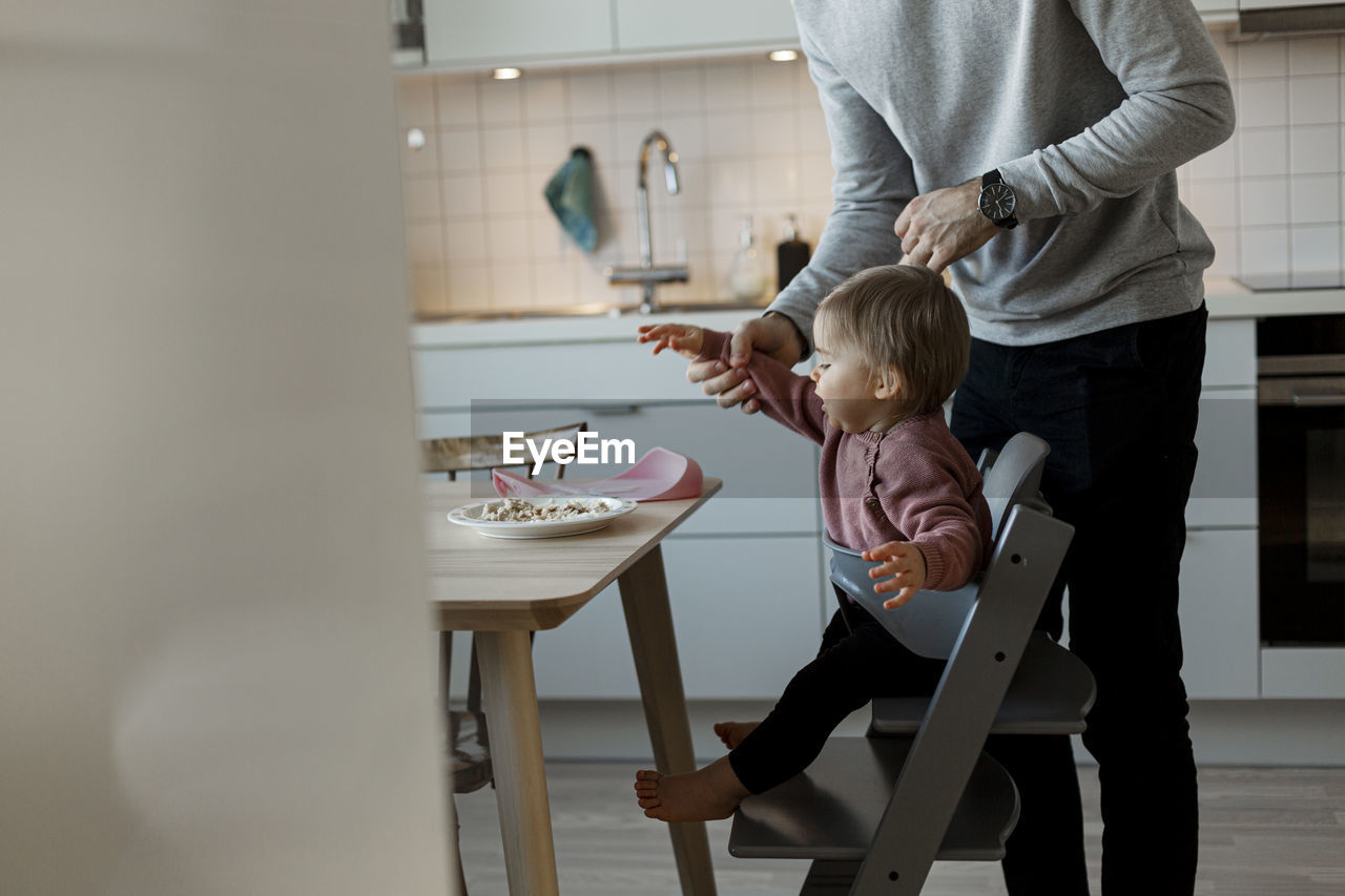 Father with daughter in kitchen