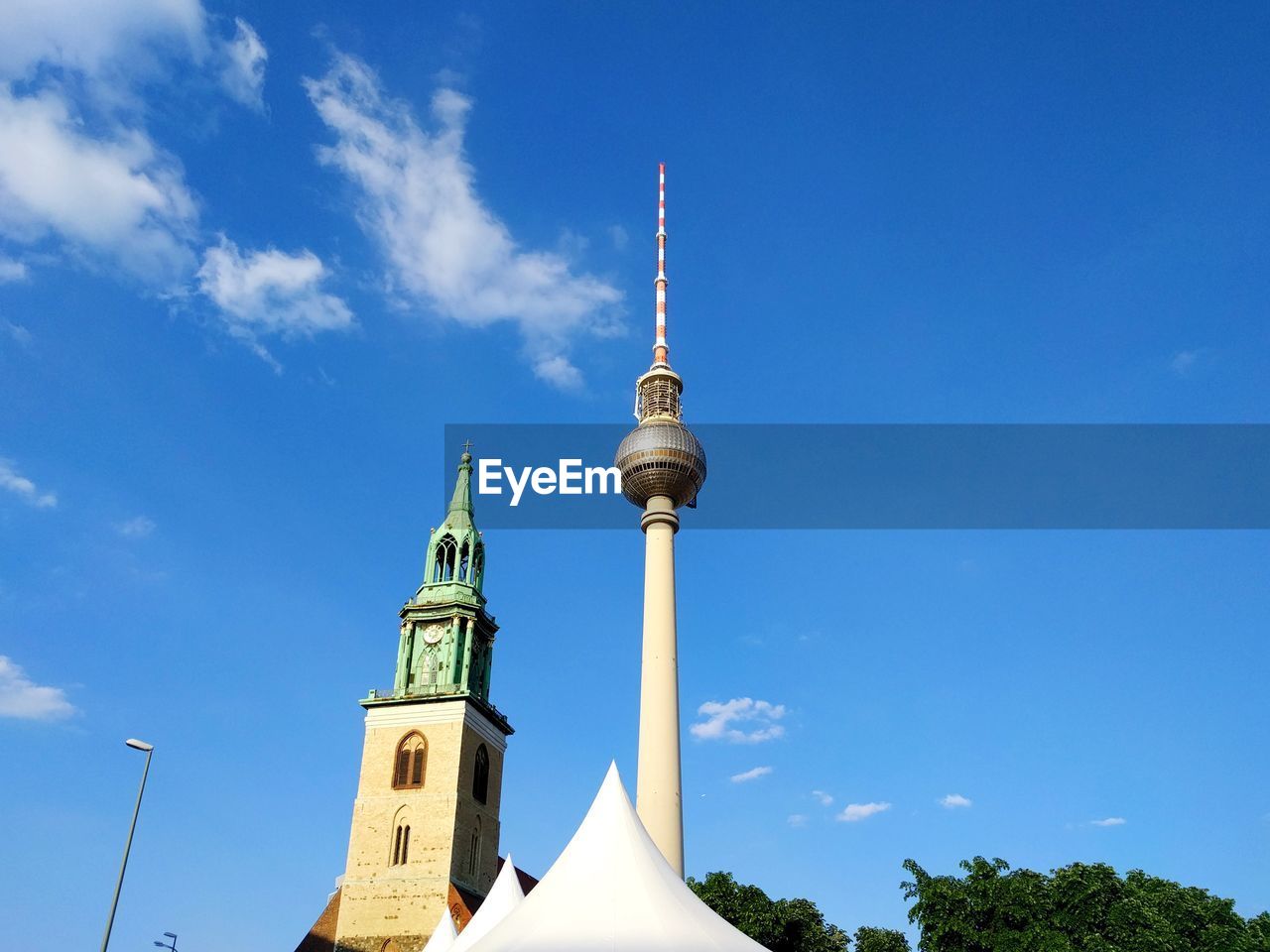 Low angle view of television tower against blue sky