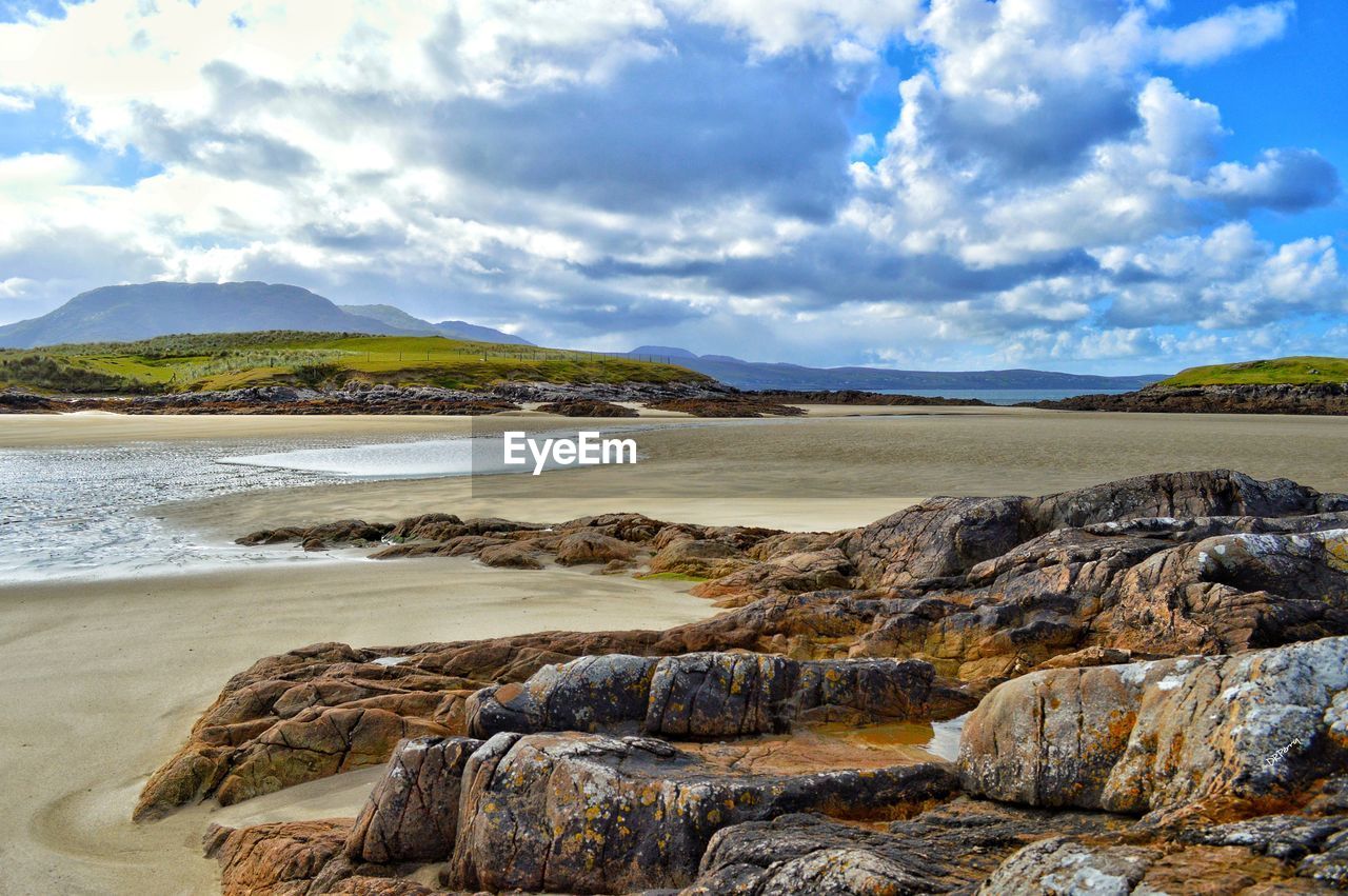 SCENIC VIEW OF SEA BY MOUNTAINS AGAINST SKY