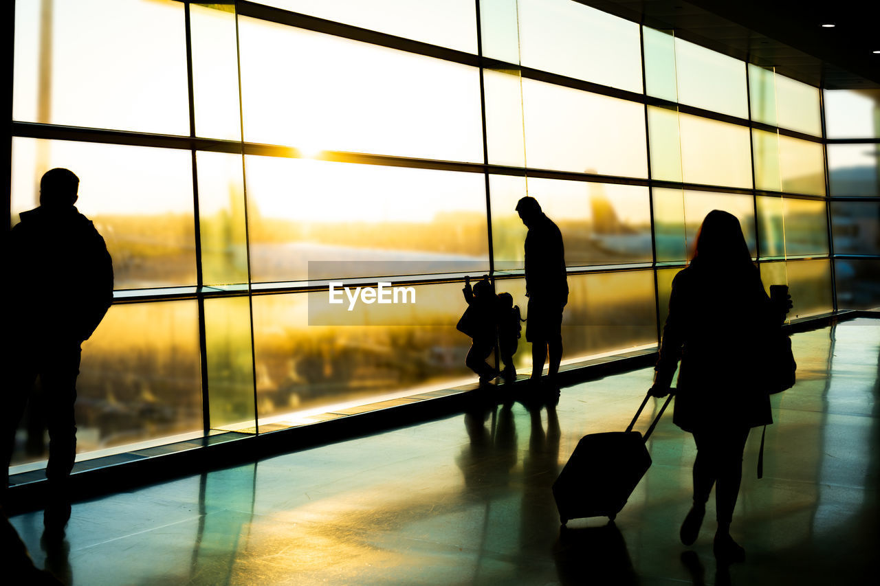 SILHOUETTE PEOPLE WAITING AT AIRPORT