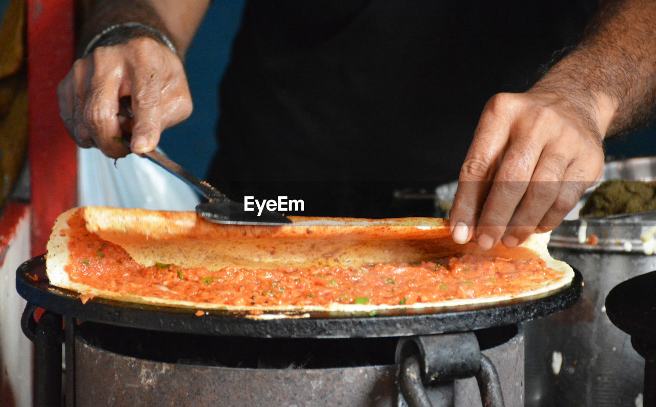 Close-up of man preparing food