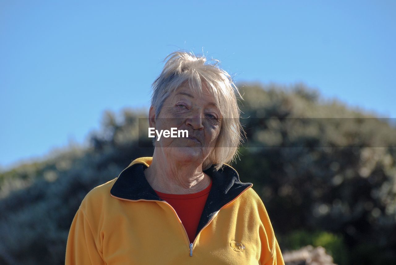 PORTRAIT OF WOMAN AGAINST SKY