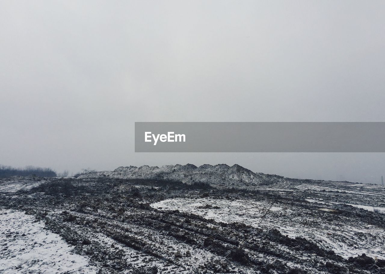 Scenic view of snowy landscape against clear sky during winter