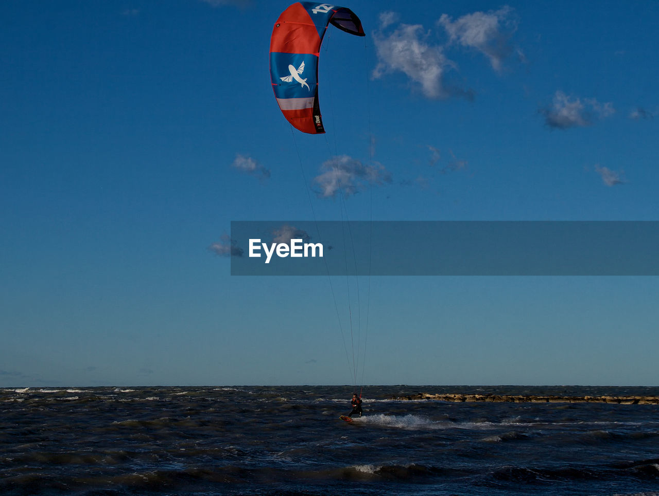 WOMAN ON SEA AGAINST SKY