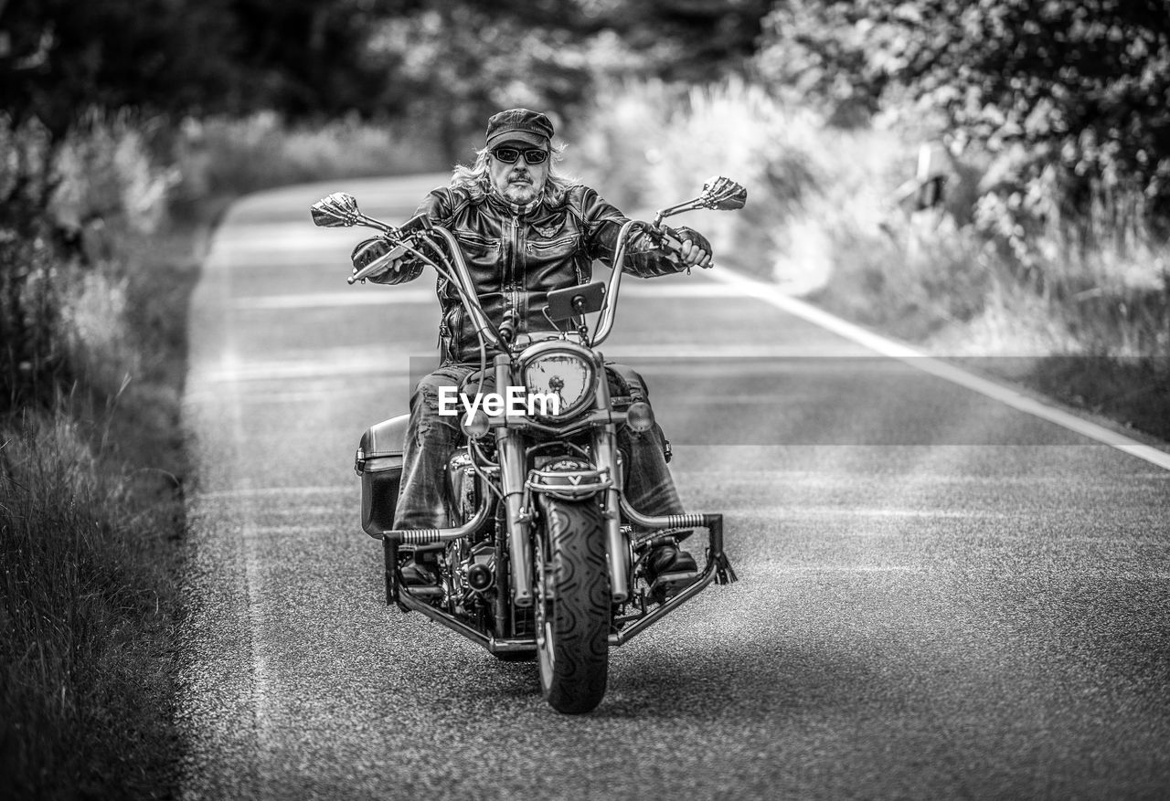 Man riding motorcycle on road