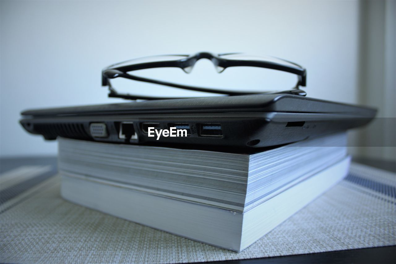 CLOSE-UP OF BOOKS ON TABLE IN SHELF