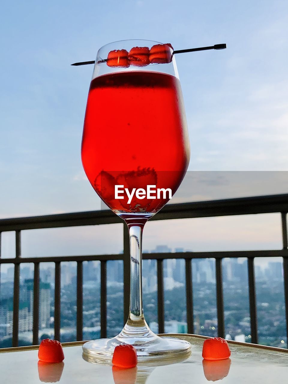 red, sky, alcohol, food and drink, drink, refreshment, nature, glass, water, sea, no people, railing, cocktail, day, wine glass, table, wine, household equipment, outdoors, drinking glass, land, beach, cloud, holiday, vacation, travel, food, trip, freshness, summer