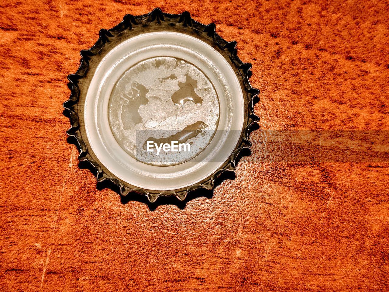 High angle view of bottle cap on wooden table