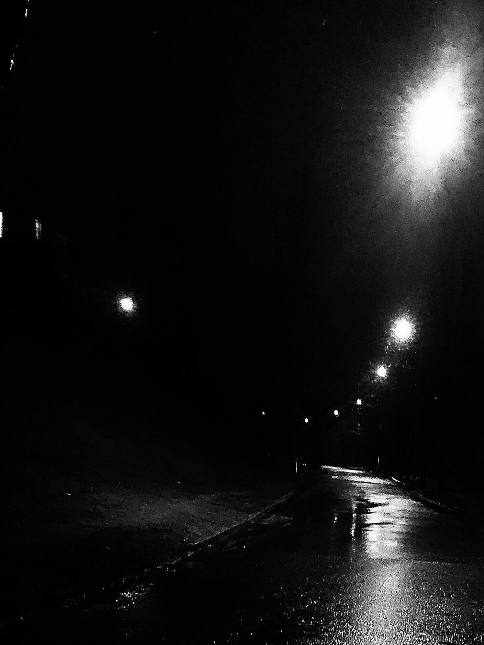 VIEW OF ILLUMINATED STREET LIGHTS AT NIGHT