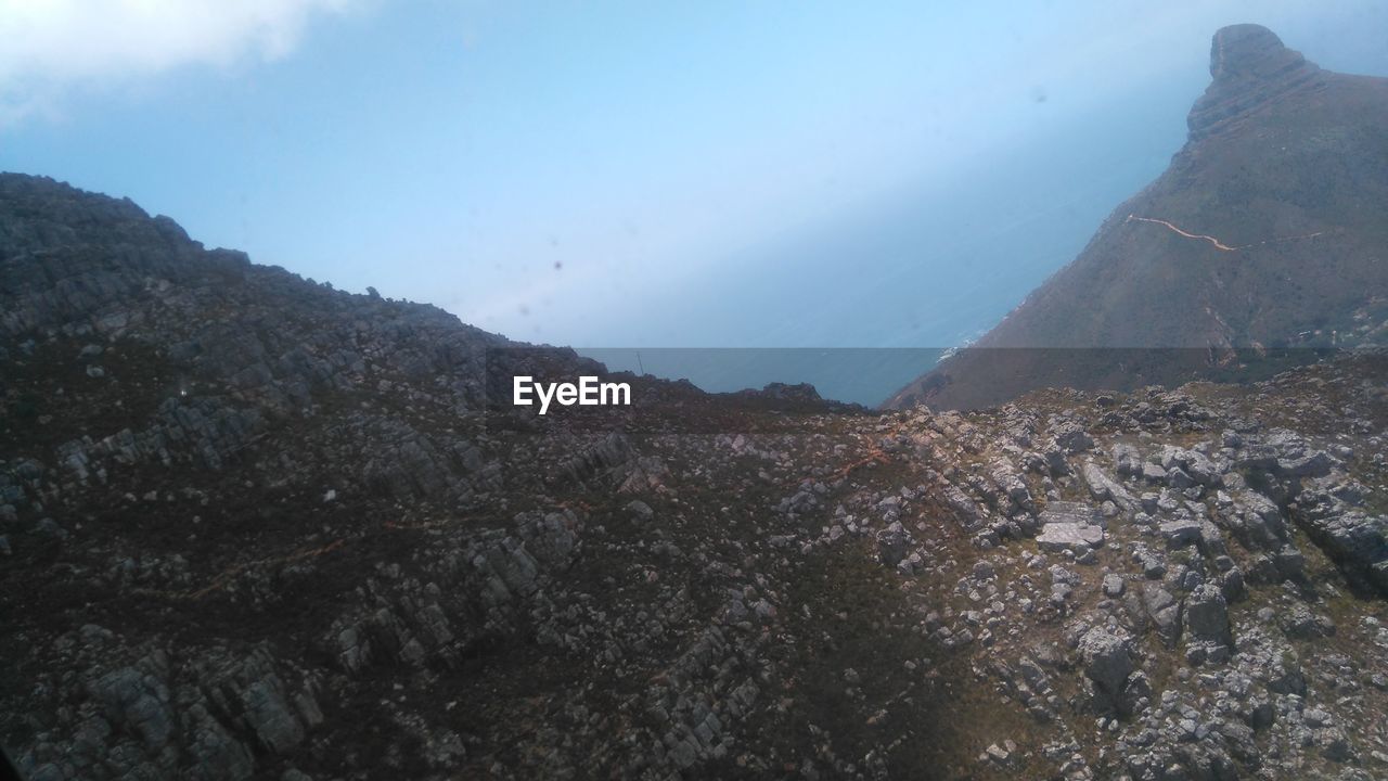CLOSE-UP OF MOUNTAIN AGAINST SKY