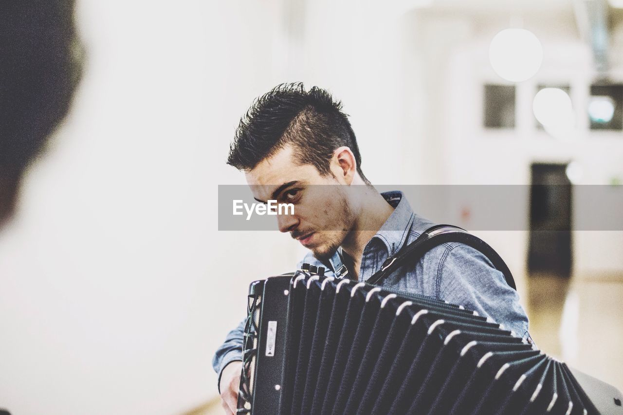 Young man playing accordion