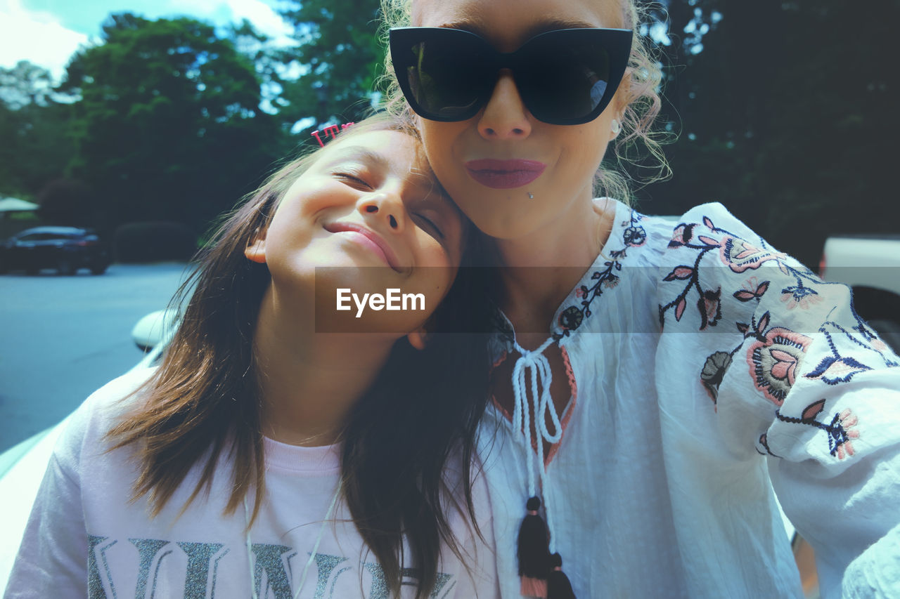 Portrait of young woman wearing sunglasses outdoors