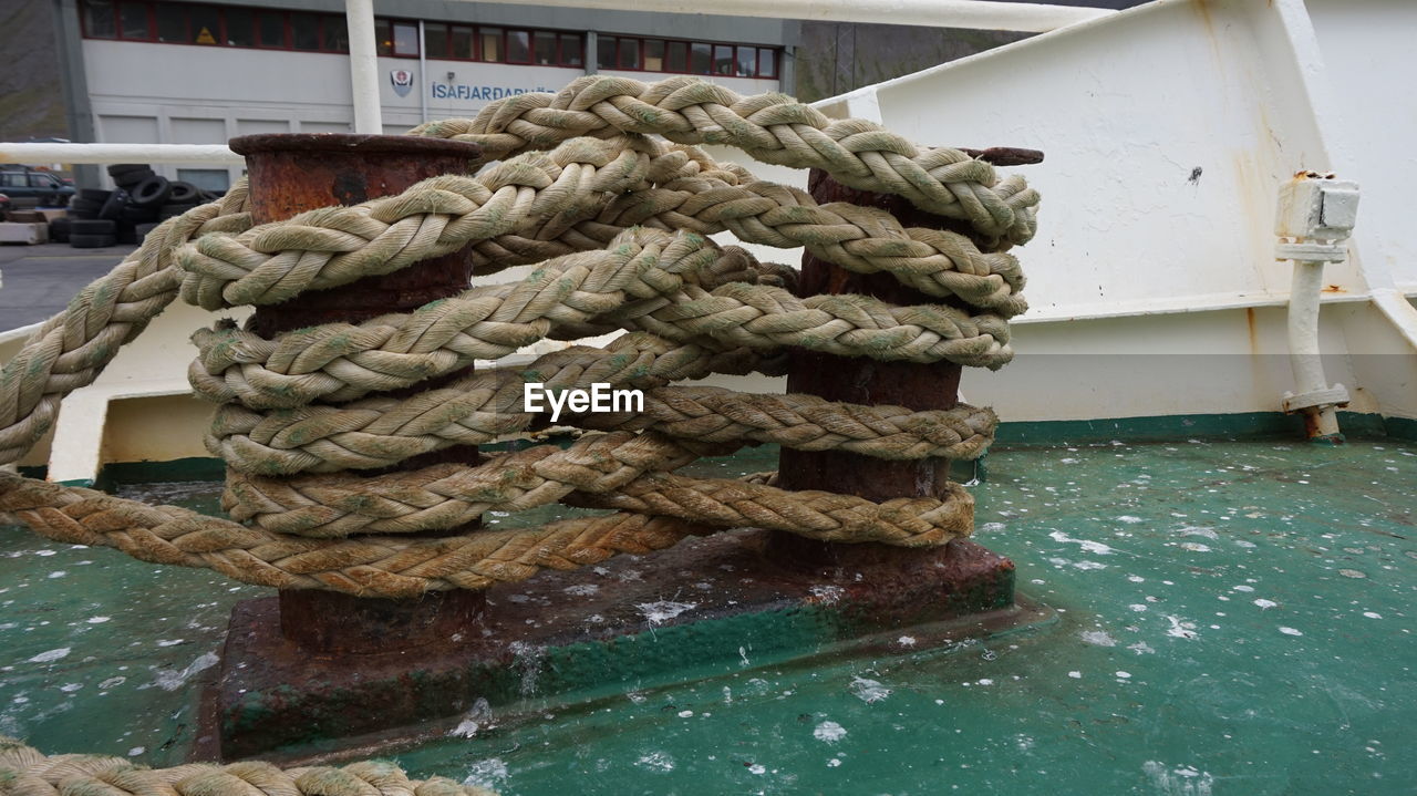 Ropes tied up on bollard in boat
