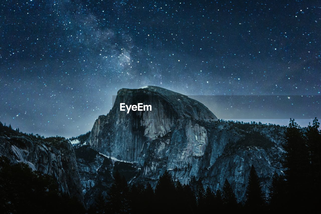 Scenic view of mountains against sky at night
