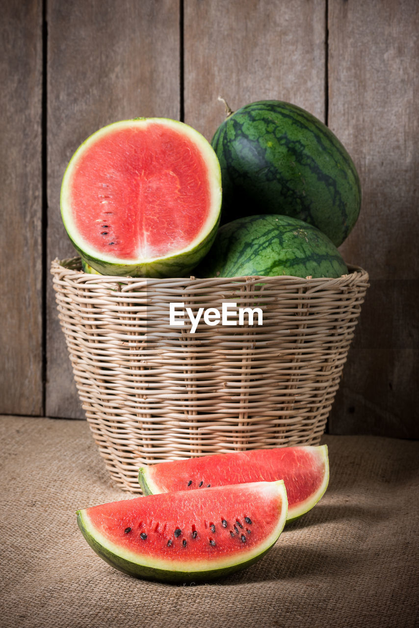 FRESH FRUITS IN BASKET WITH STRAWBERRIES IN CONTAINER