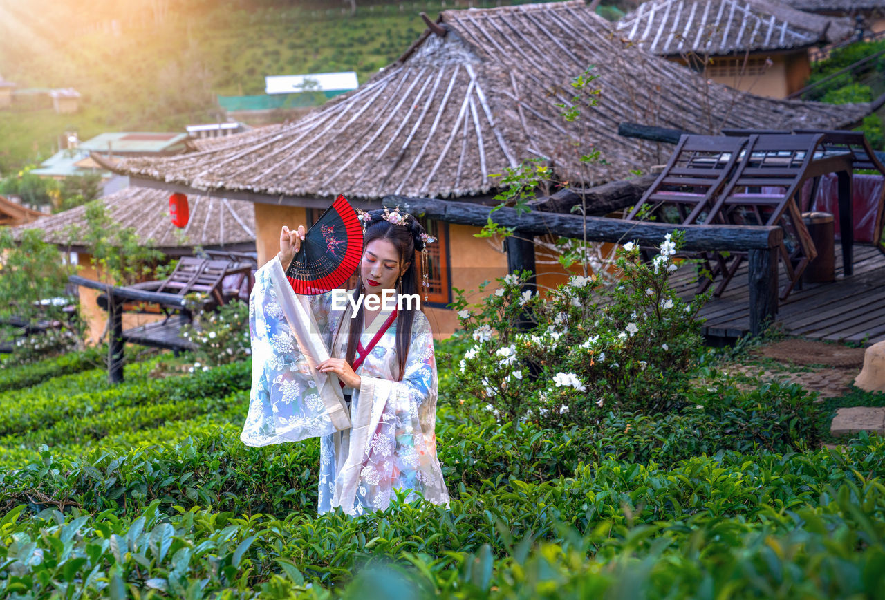 Woman standing by plants