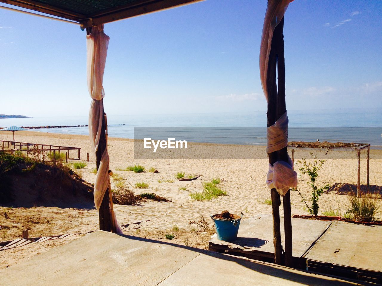 View of calm beach against clear sky