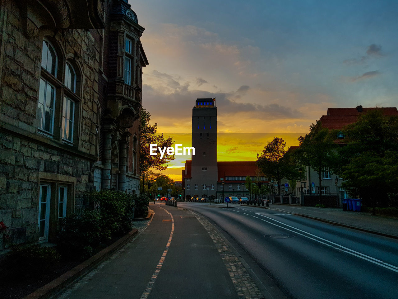 City street against sky during sunset