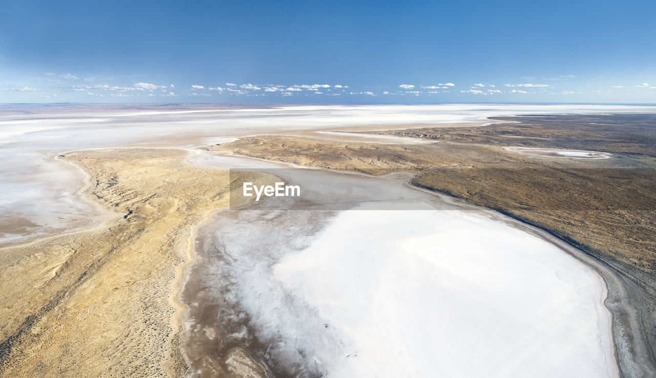 Aerial view of lake eyre by coastline against sky