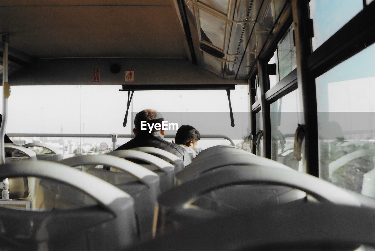 Rear view of people traveling in bus