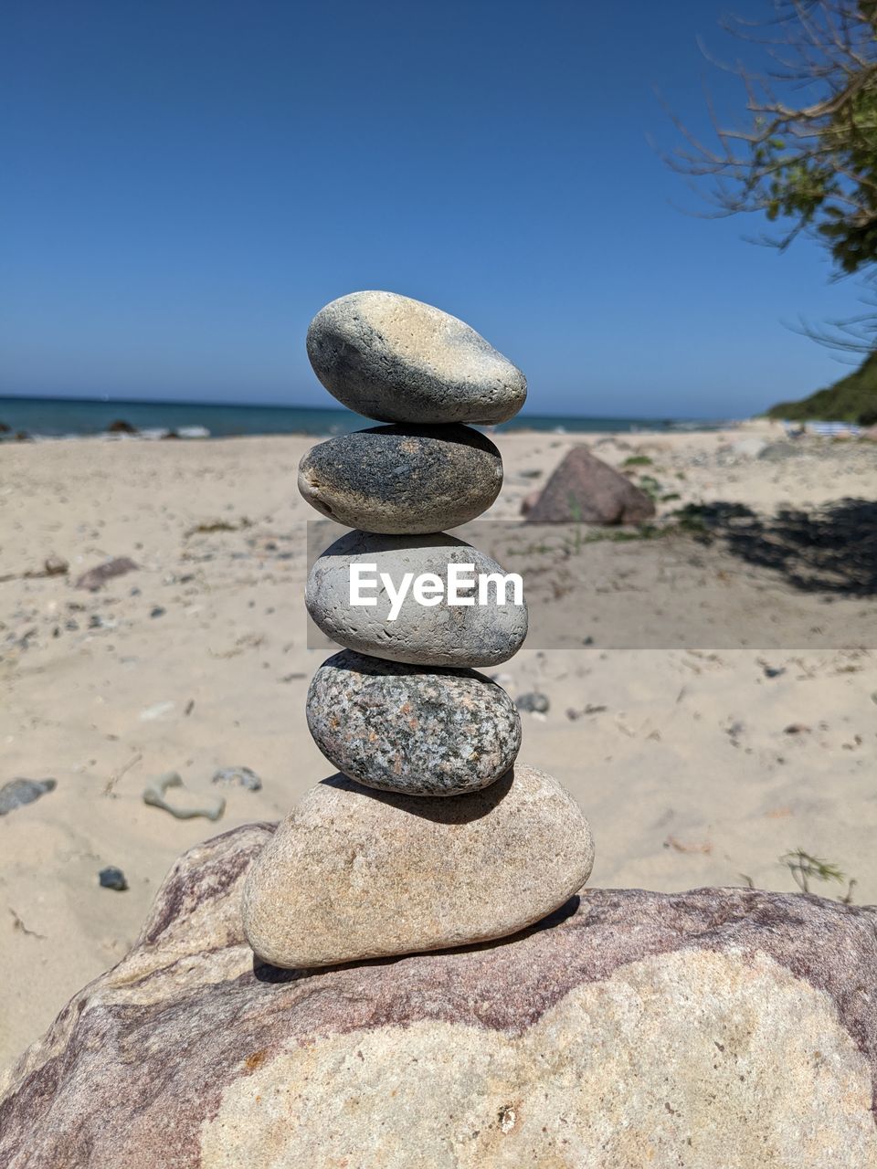 rock, balance, land, zen-like, beach, sand, sky, nature, stone, pebble, tranquility, shore, sea, water, tranquil scene, clear sky, coast, no people, scenics - nature, beauty in nature, day, blue, outdoors, sunlight, sunny, landscape, body of water, horizon, environment, stability, ocean