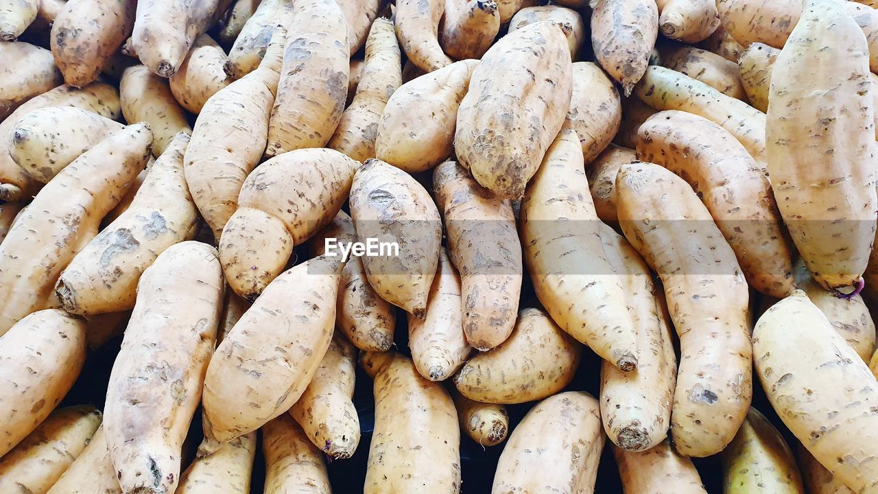 Full frame shot of sweet potatoes for sale at market stall