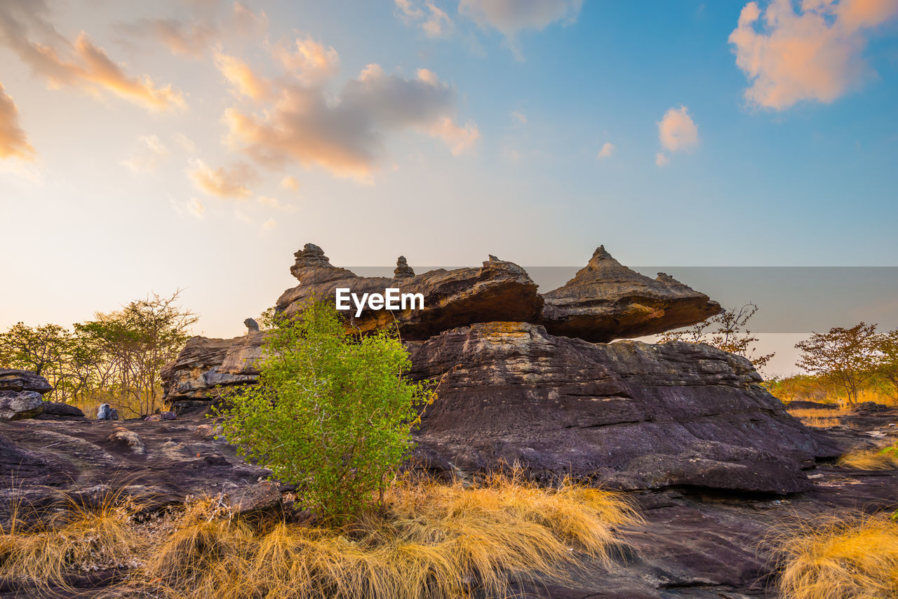 ROCK FORMATION ON LAND AGAINST SKY