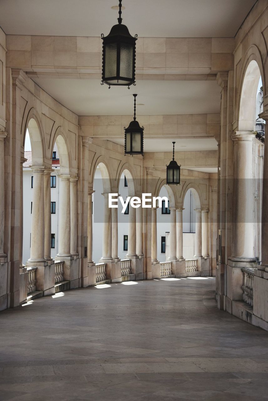 CORRIDOR OF BUILDING WITH COLONNADE IN BACKGROUND