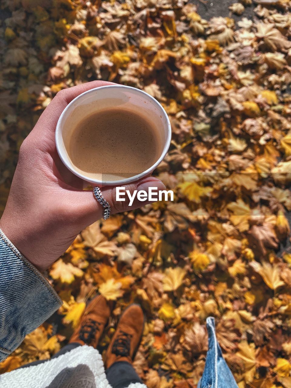 Midsection of person holding coffee cup