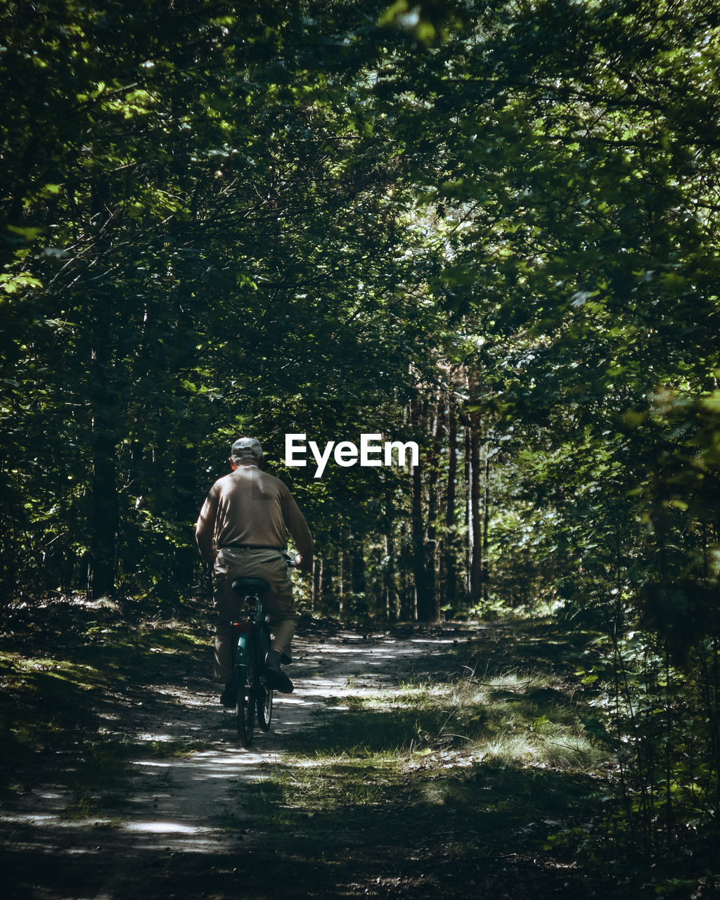 Rear view of man riding bicycle