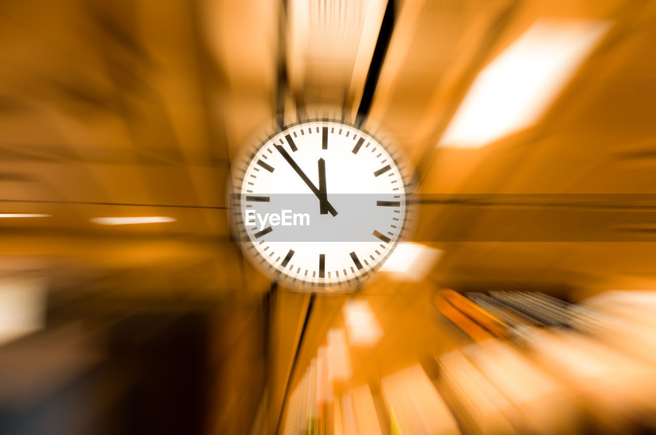 Close-up of clock hanging from ceiling