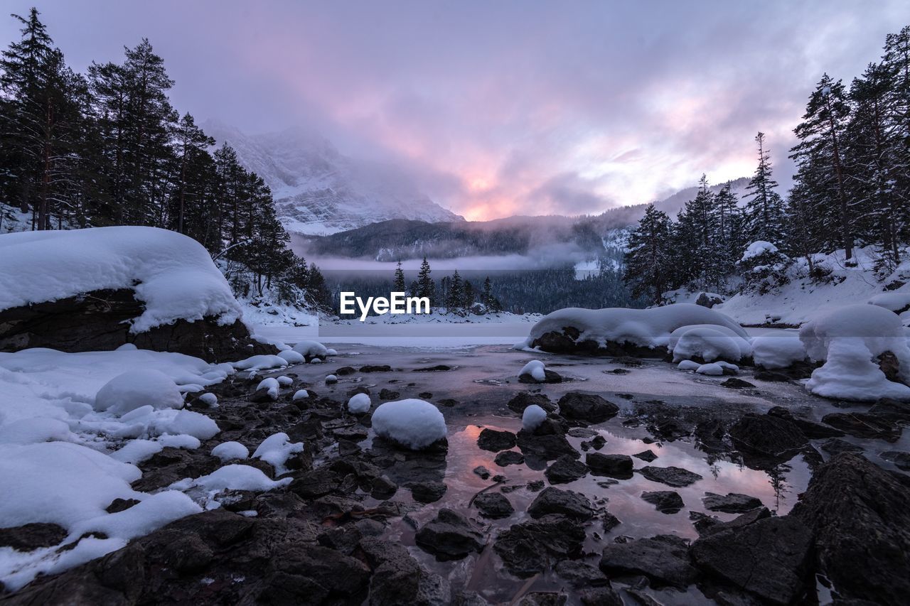 Scenic view of frozen lake against sky during winter