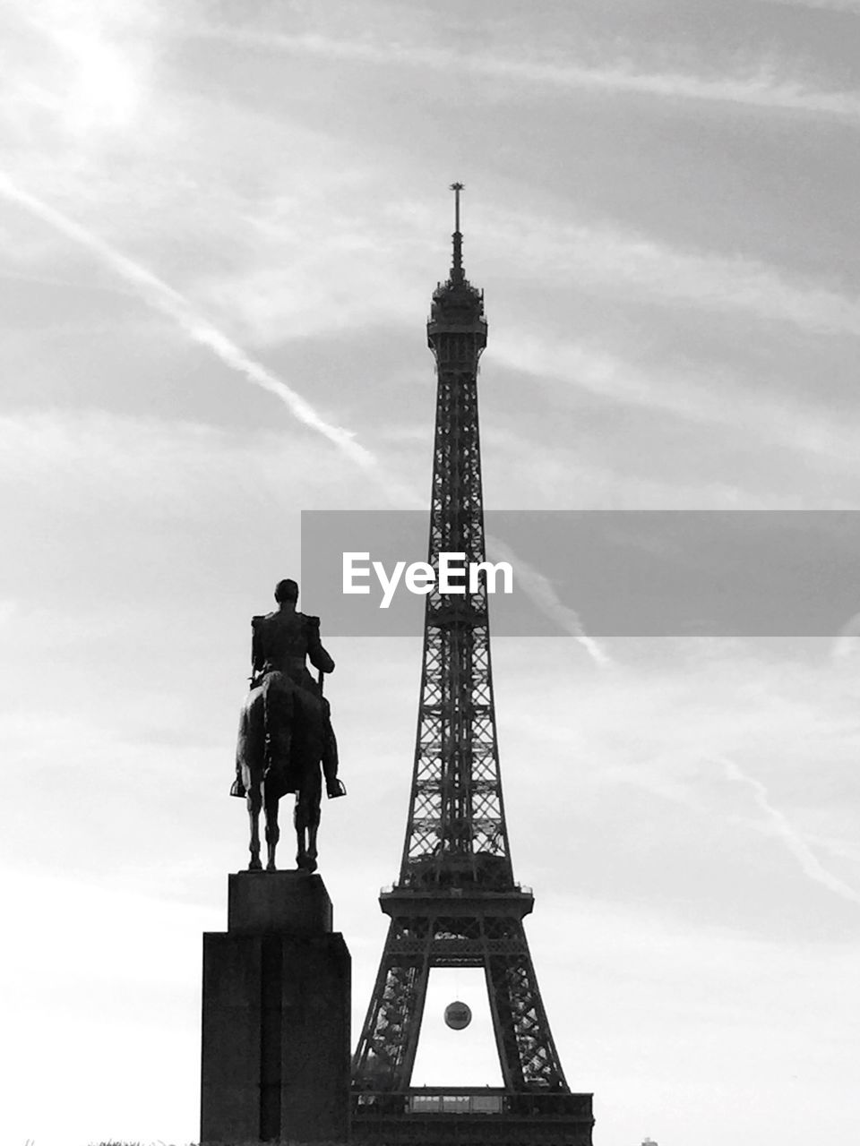 Low angle view of statue and eiffel tower against sky