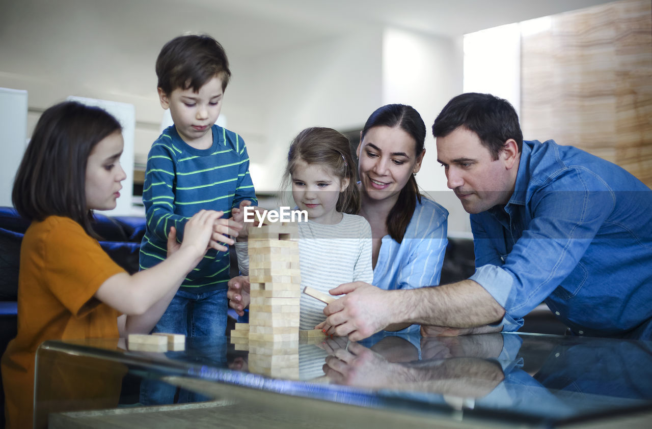 side view of mother and son sitting on table